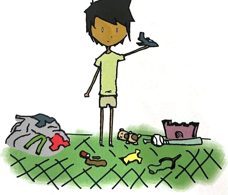 A boy flies a toy plane while clothes and toys are scattered on the floor.