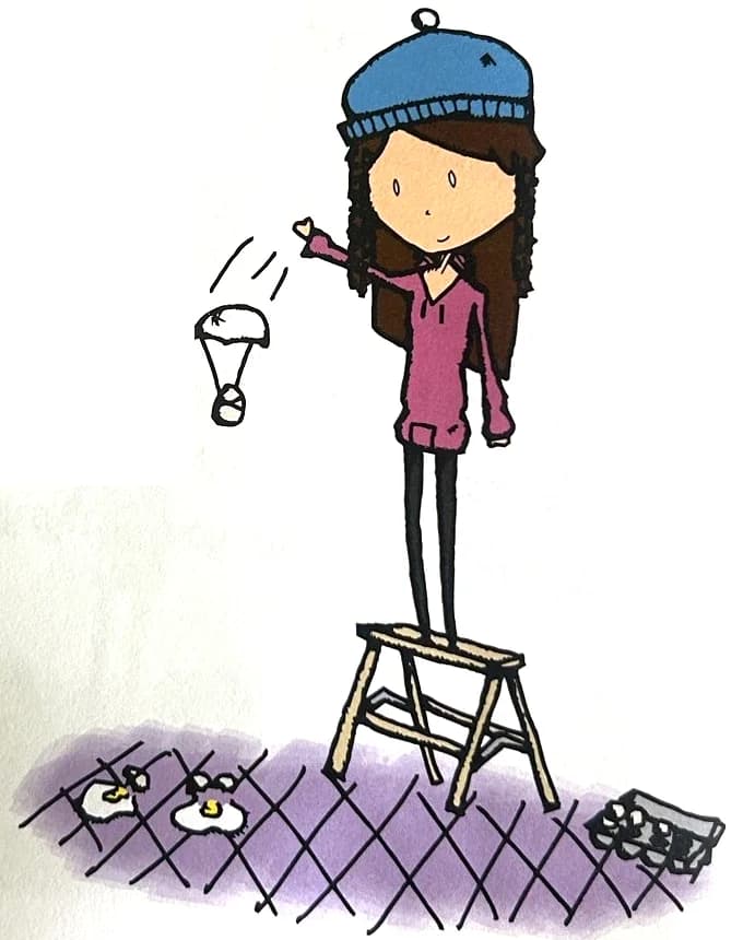 A girl on a step stool drops an egg with a tiny parachute.