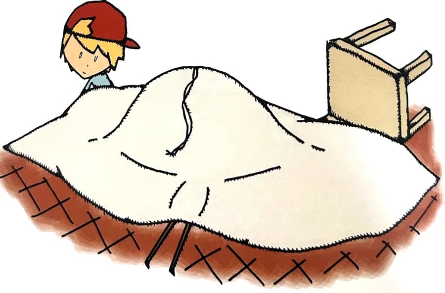A boy peeks out from a collapsed blanket fort with a tipped-over chair.